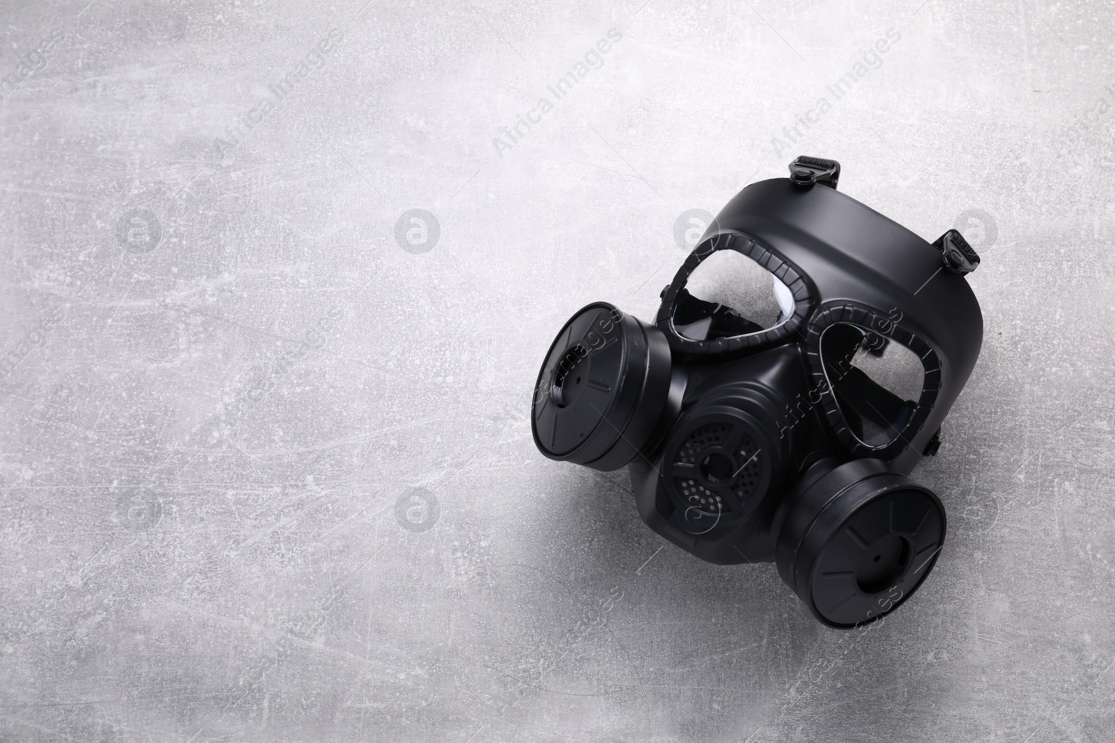 Photo of One gas mask on grey textured background, top view. Space for text