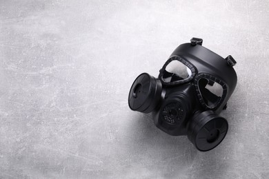 Photo of One gas mask on grey textured background, top view. Space for text