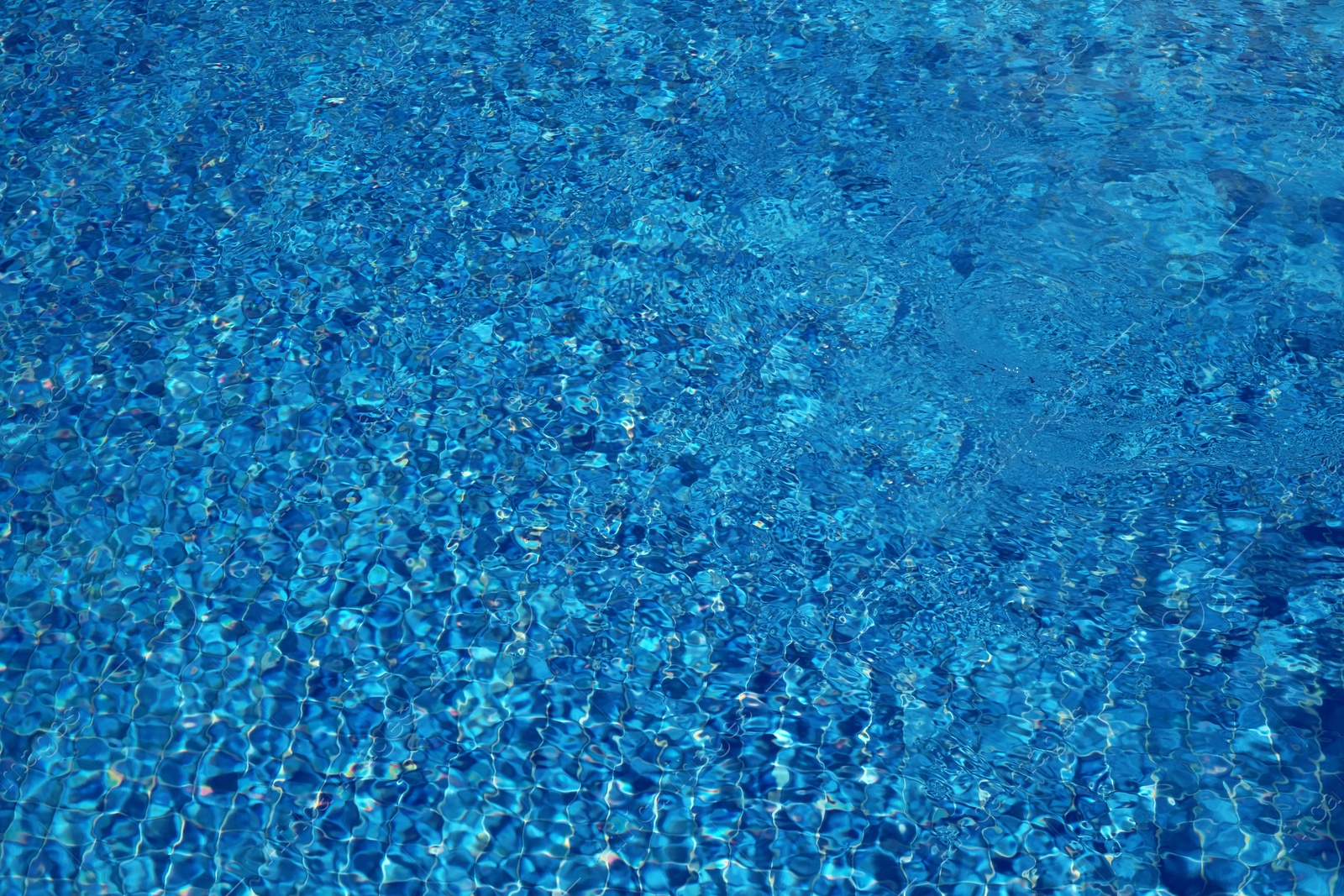 Photo of Outdoor swimming pool with clear water on sunny day