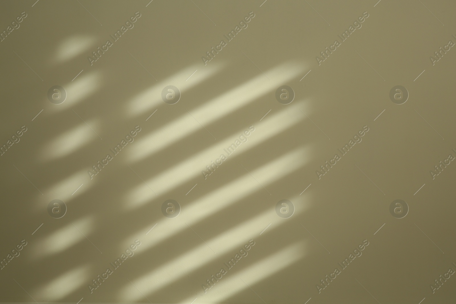 Photo of Light and shadow from window on beige wall indoors