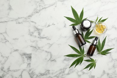 Photo of Composition with CBD oil, THC tincture and hemp leaves on white marble table, flat lay. Space for text
