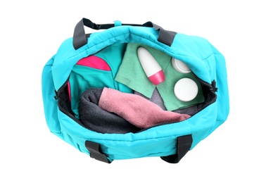 Photo of Sport bag with deodorant and clothes on white background, top view