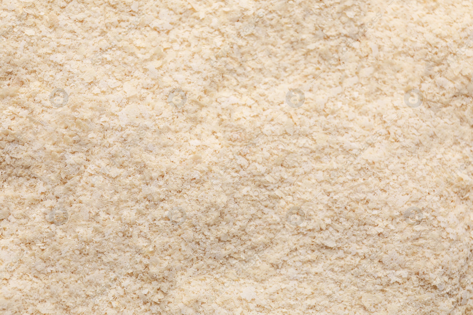Photo of Brewer`s yeast flakes as background, closeup view