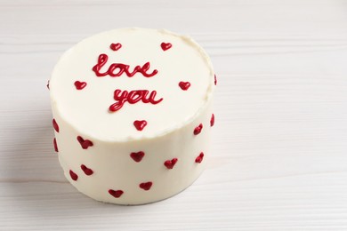 Photo of Bento cake with text Love You on white wooden table, space for text. St. Valentine's day surprise