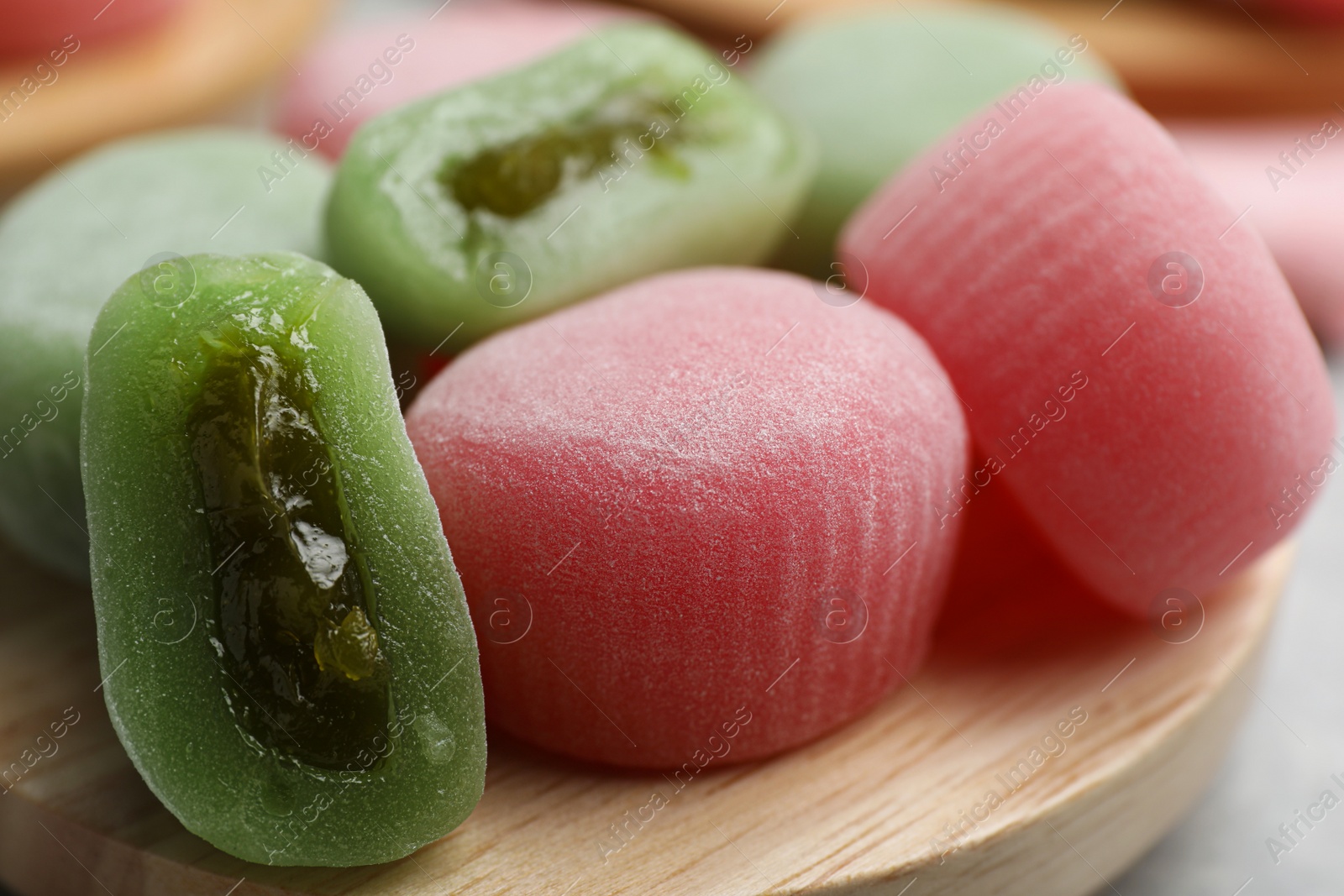 Photo of Many different delicious mochi on wooden board, closeup. Traditional Japanese dessert