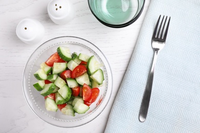 Photo of Flat lay composition with delicious fresh cucumber tomato salad on table