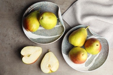 Composition with ripe juicy pears on grey stone table, flat lay