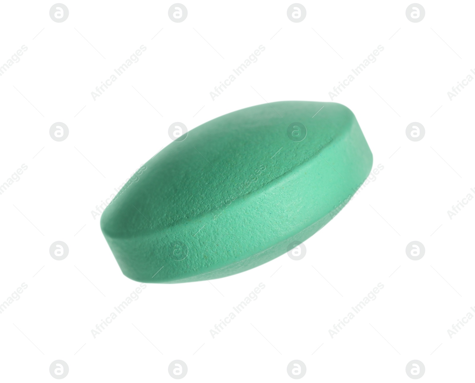 Photo of One green pill on white background. Medicinal treatment