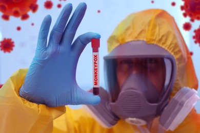 Image of Scientist in chemical protective suit holding test tube with blood sample. Monkeypox virus