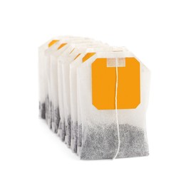 Photo of Many new tea bags on white background