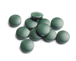 Photo of Spirulina tablets on white background. Healthy lifestyle