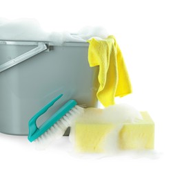 Photo of Plastic bucket with foam and sponge on white background. Cleaning supplies