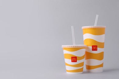 Photo of MYKOLAIV, UKRAINE - AUGUST 12, 2021: Cold McDonald's drinks on light background. Space for text