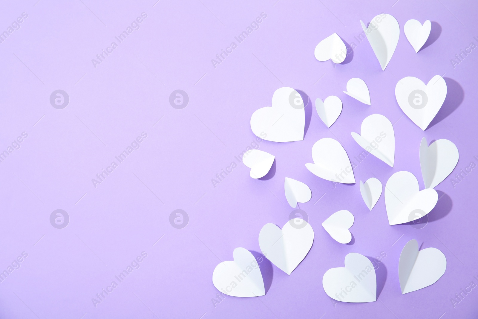 Photo of Small paper hearts on color background, top view