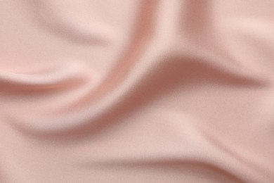 Crumpled pink silk fabric as background, top view