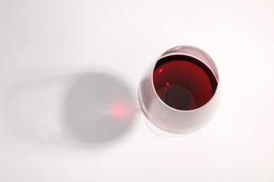 Tasty red wine in glass isolated on white, above view