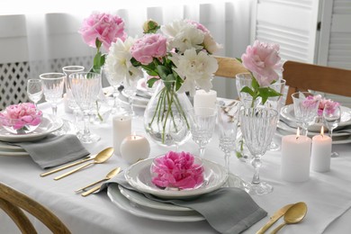 Stylish table setting with beautiful peonies in dining room