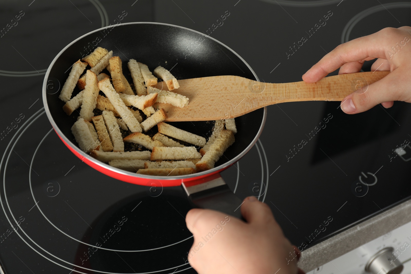 Photo of Woman cooking hard chucks on cooktop, closeup