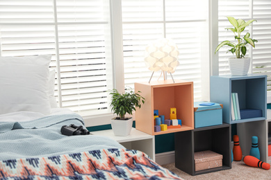 Photo of Modern child room interior with comfortable bed near window