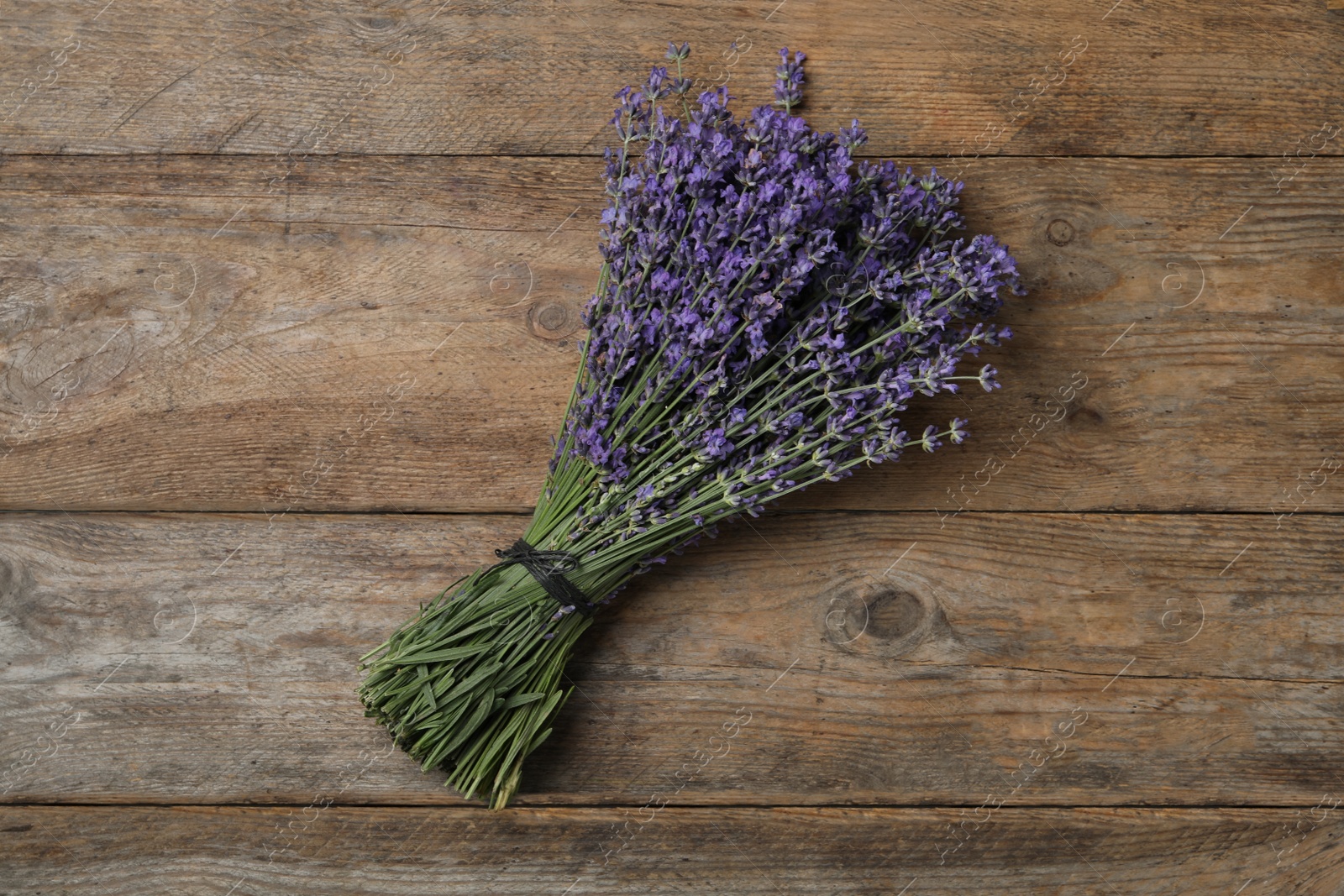 Photo of Beautiful lavender bouquet on wooden background, top view