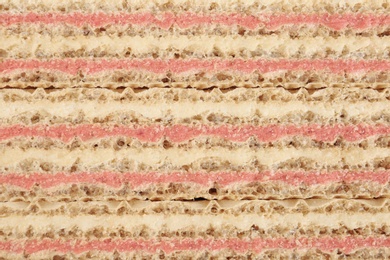 Wafer sticks with pink filling as background, closeup. Sweet food