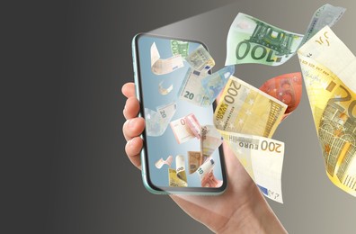 Image of Online wallet. Woman using mobile phone on dark background, closeup. Euro banknotes flying from device screen