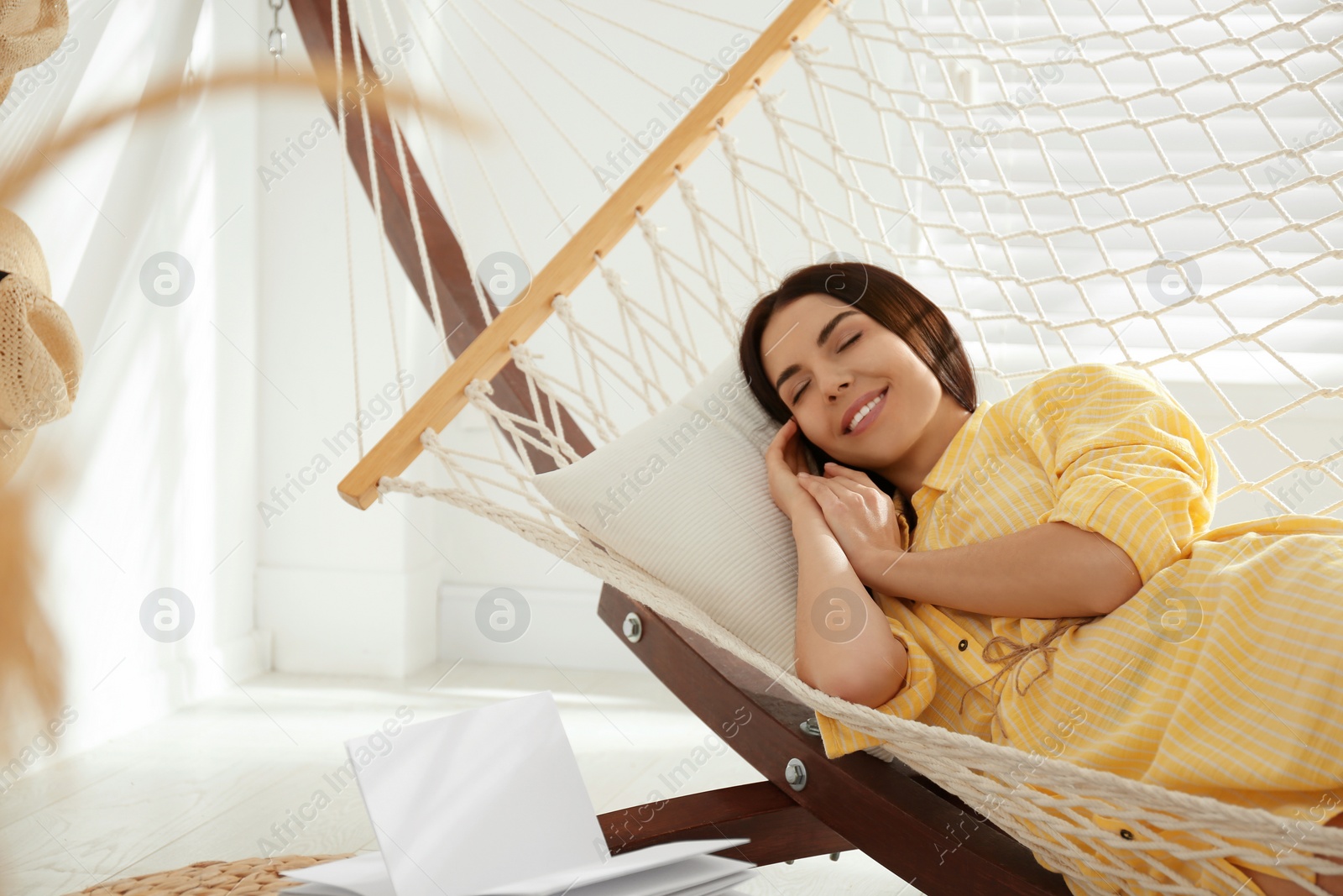 Photo of Young woman relaxing in hammock at home