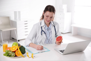 Female nutritionist working at desk in office