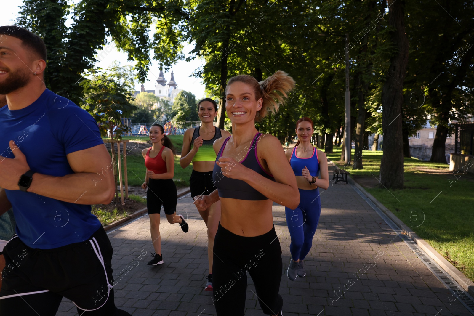 Photo of Group of people running in park. Active lifestyle