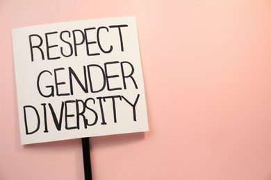 Photo of Sign with phrase Respect Gender Diversity on pink background, top view. Space for text