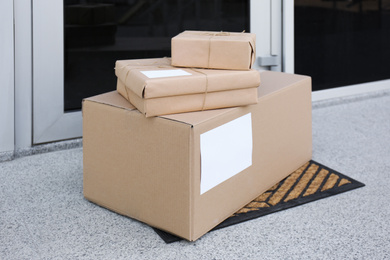 Photo of Delivered parcels on door mat near entrance