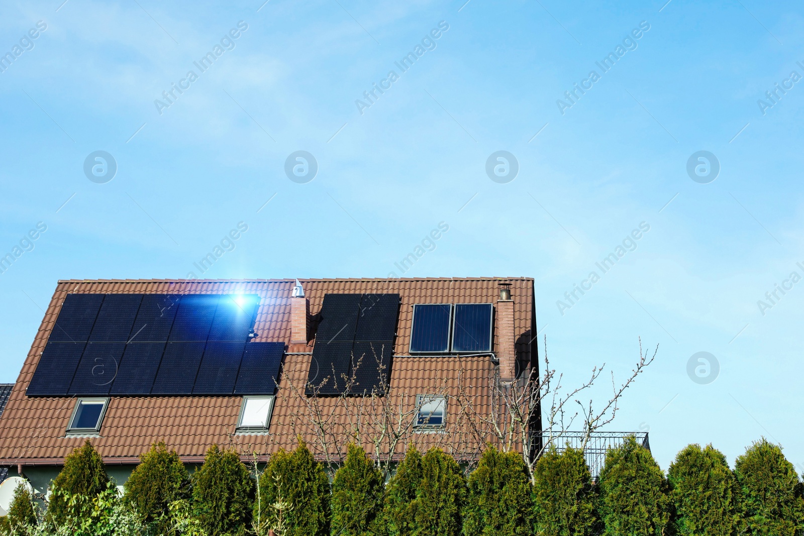 Photo of House with installed solar panels on roof, space for text. Alternative energy