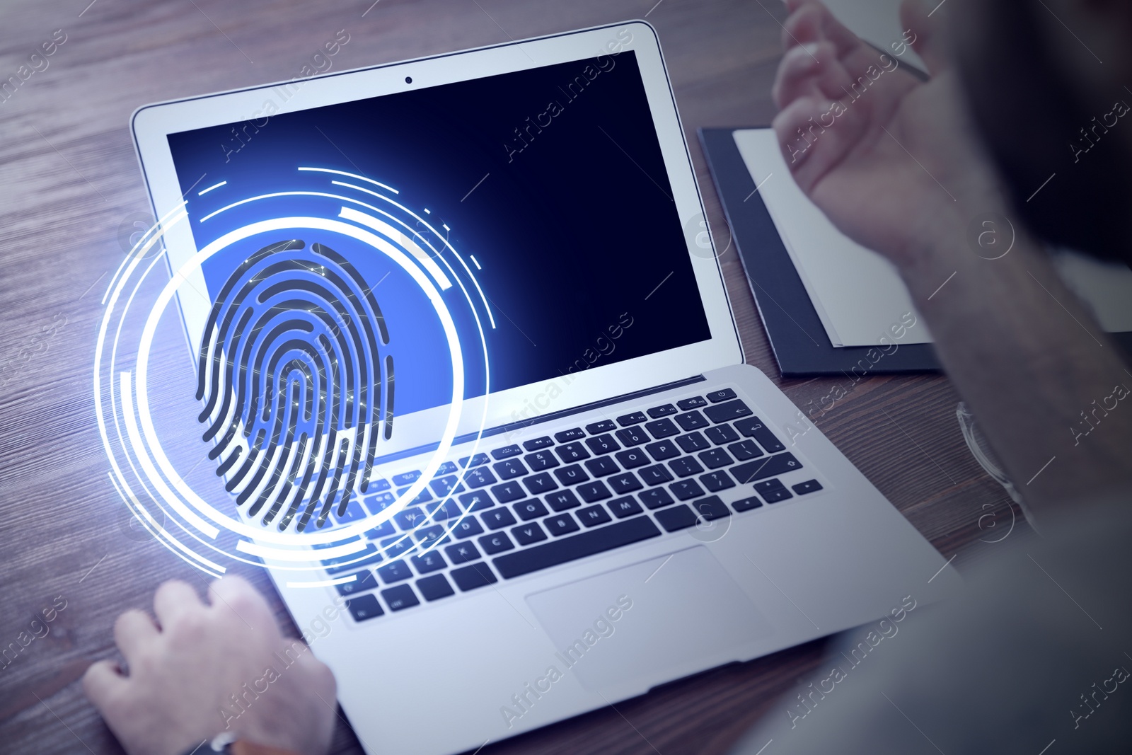 Image of Fingerprint identification. Man working with laptop at table, closeup