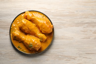 Tasty chicken curry on wooden table, top view. Space for text