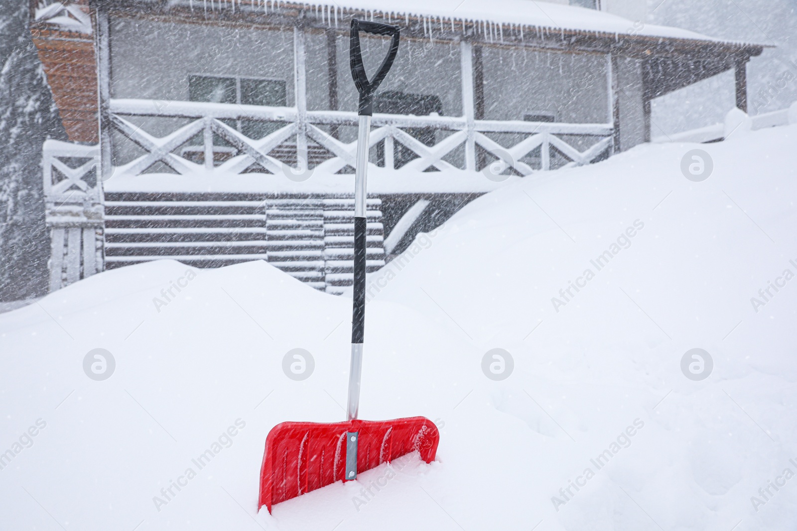 Photo of Snow cleaning shovel near house. Winter outdoor work