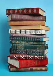 Photo of Stack of hardcover books on light blue background