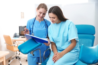 Photo of Pregnant woman having appointment at gynecologist office