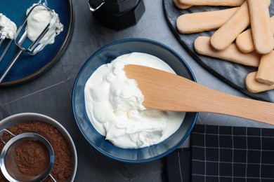 Flat lay composition with different ingredients for tiramisu on black table