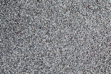 Photo of Heap of poppy seeds as background, top view. Veggie food