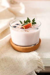 Photo of Delicious fig smoothie in glass on white wooden table