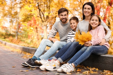 Photo of Happy family with children spending time in park. Autumn walk