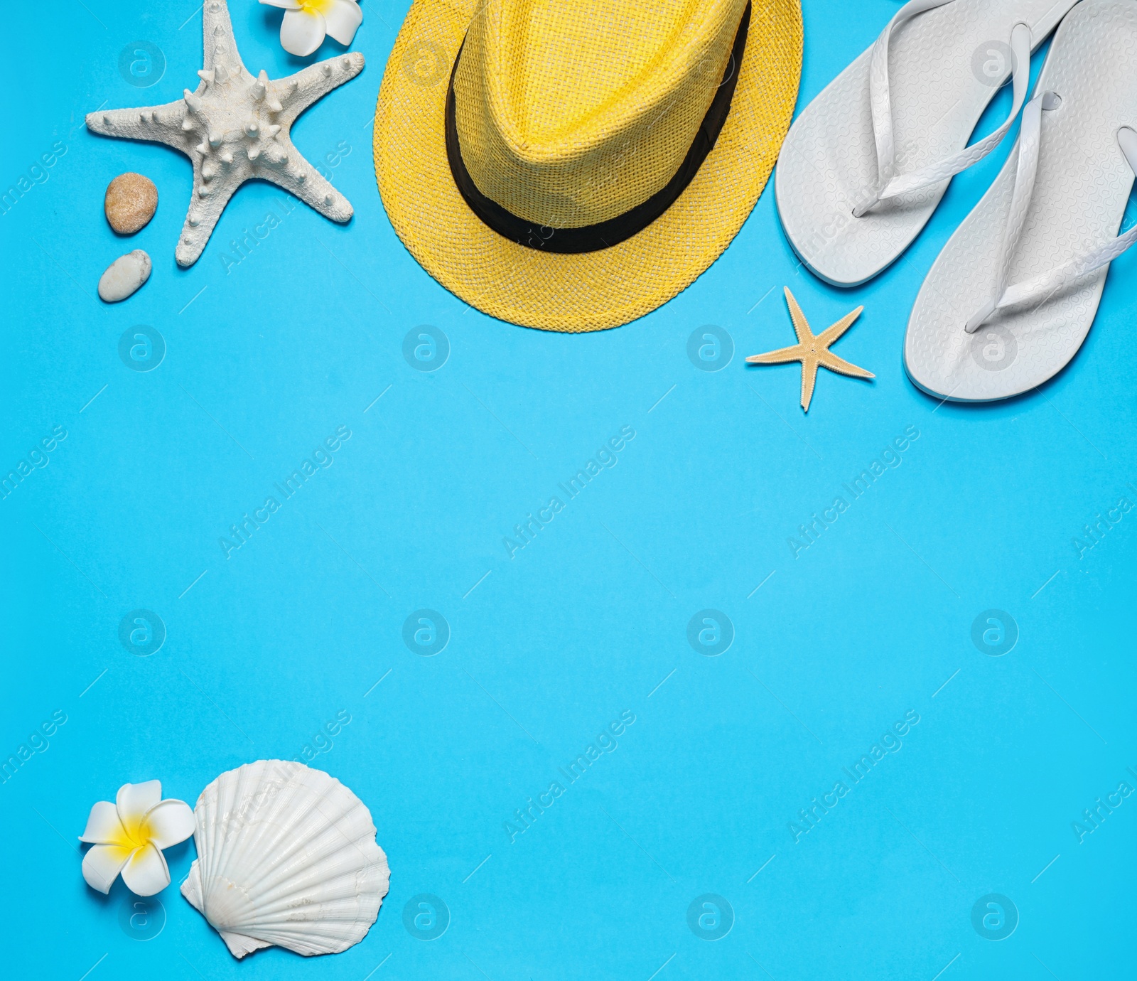 Photo of Flat lay composition with stylish beach accessories on light blue background, space for text