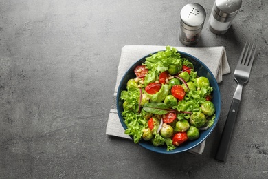 Photo of Salad with Brussels sprouts served on grey table, flat lay. Space for text