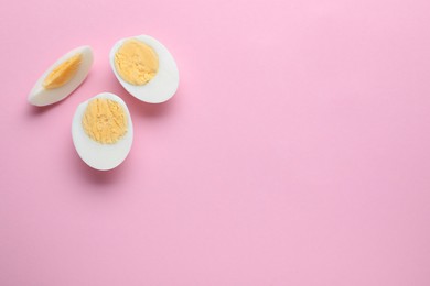 Photo of Fresh hard boiled eggs on pink background, flat lay. Space for text