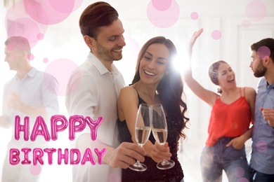 Image of Lovely young couple with glasses of champagne at birthday party 