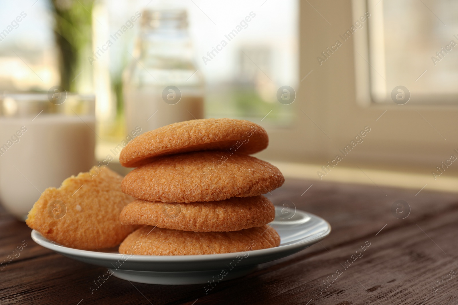 Photo of Delicious Danish butter cookies on wooden table, closeup. Space for text