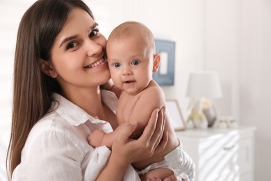 Photo of Happy young mother with her cute baby at home