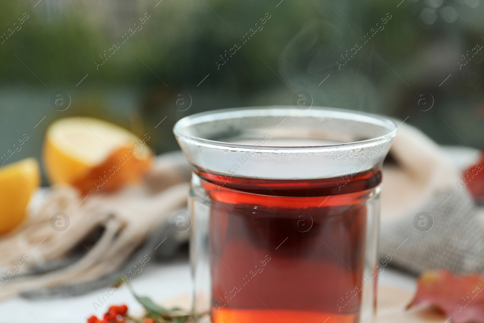 Photo of Cup of hot drink on window sill, closeup. Cozy autumn atmosphere