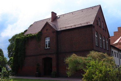 Photo of Beautiful house with brown roof against blue sky