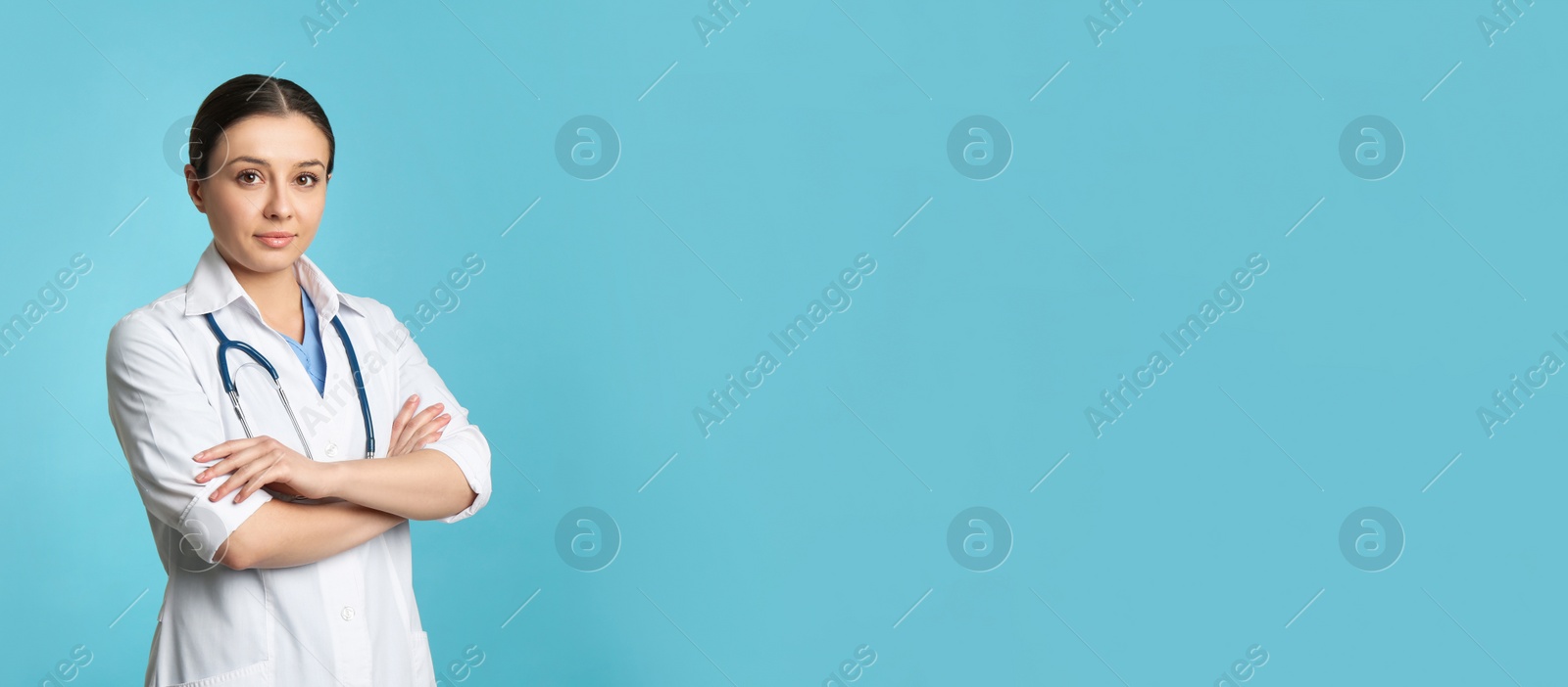 Photo of Pediatrician with stethoscope on turquoise background, space for text